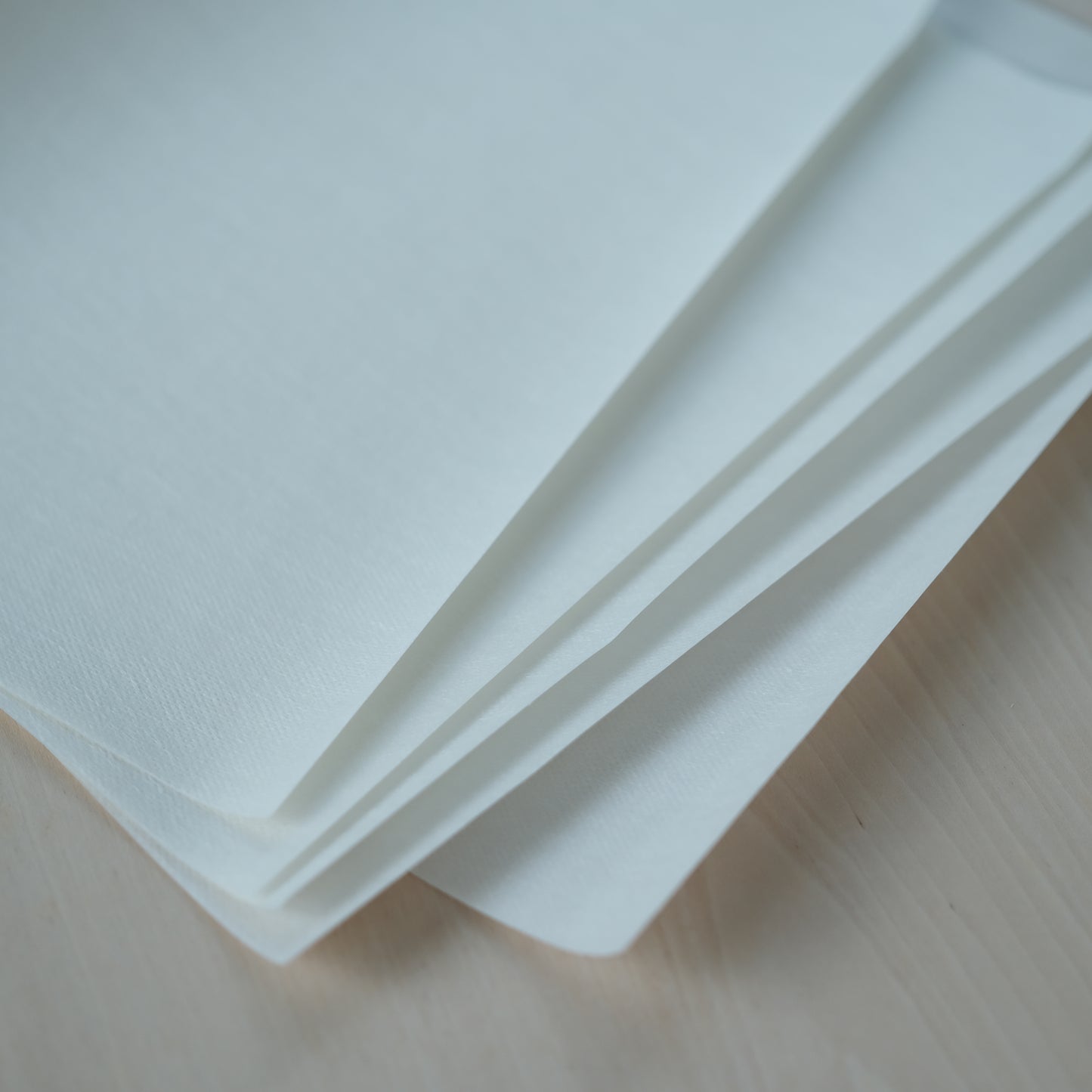 Close-up stack of blank printable Stick 'n Stitch sheets for custom embroidery designs.