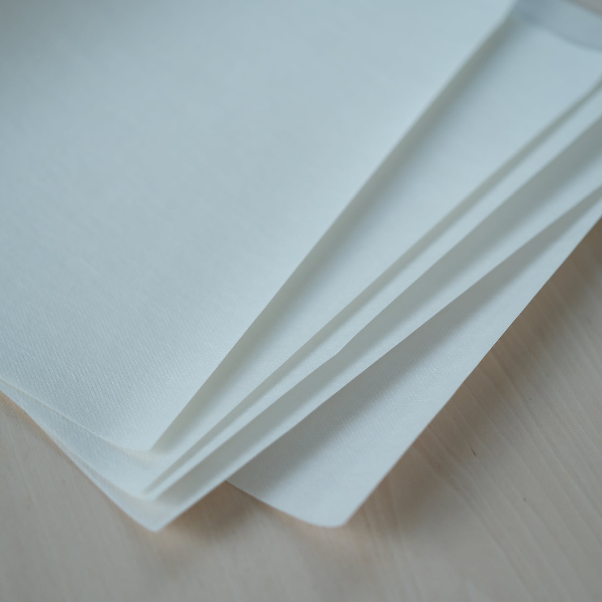 Close-up stack of blank printable Stick 'n Stitch sheets for custom embroidery designs.