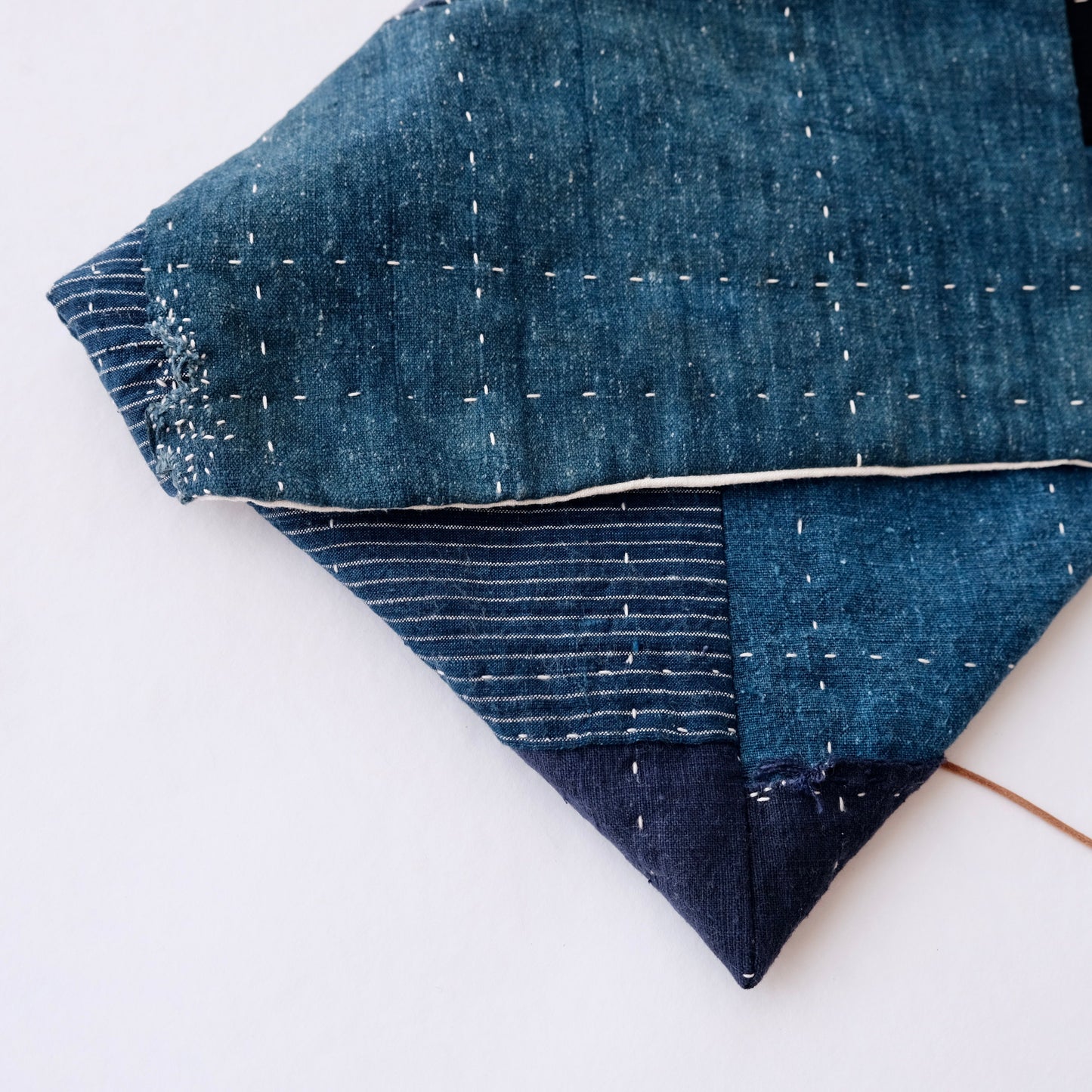 A laptop sleeve created using antique indigo fabrics from the Boro fabric bundle.