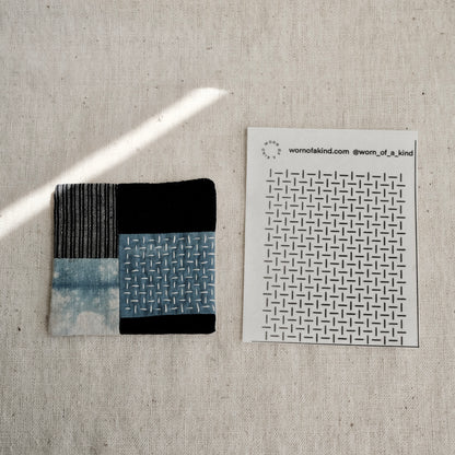 A finished Boro-style patched fabric coaster featuring the alternating Hitomezashi grid pattern.