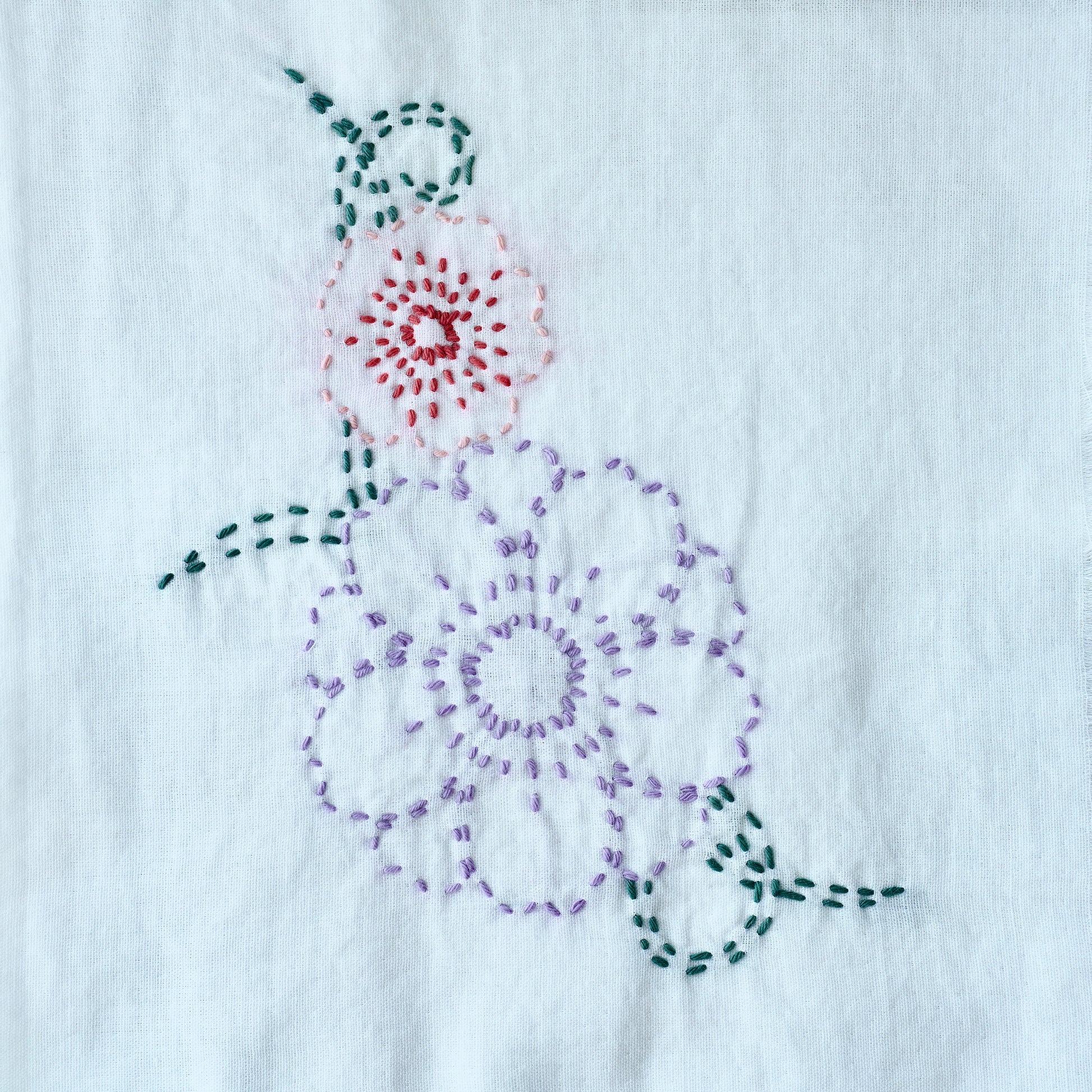 Finished Sashiko flower embroidery for the letter F in a minimalist style.