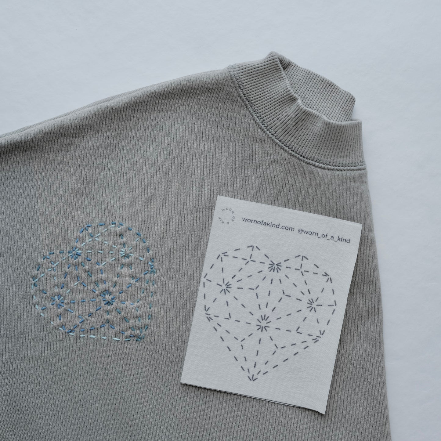 Detailed view of multiple diamond heart Sashiko patterns stitched onto a comfortable sweatshirt.