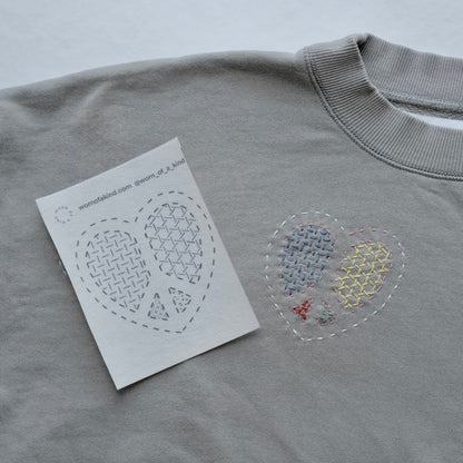 A single heart-shaped Sashiko transfer sticker from the Love Mends Valentine's Edition.