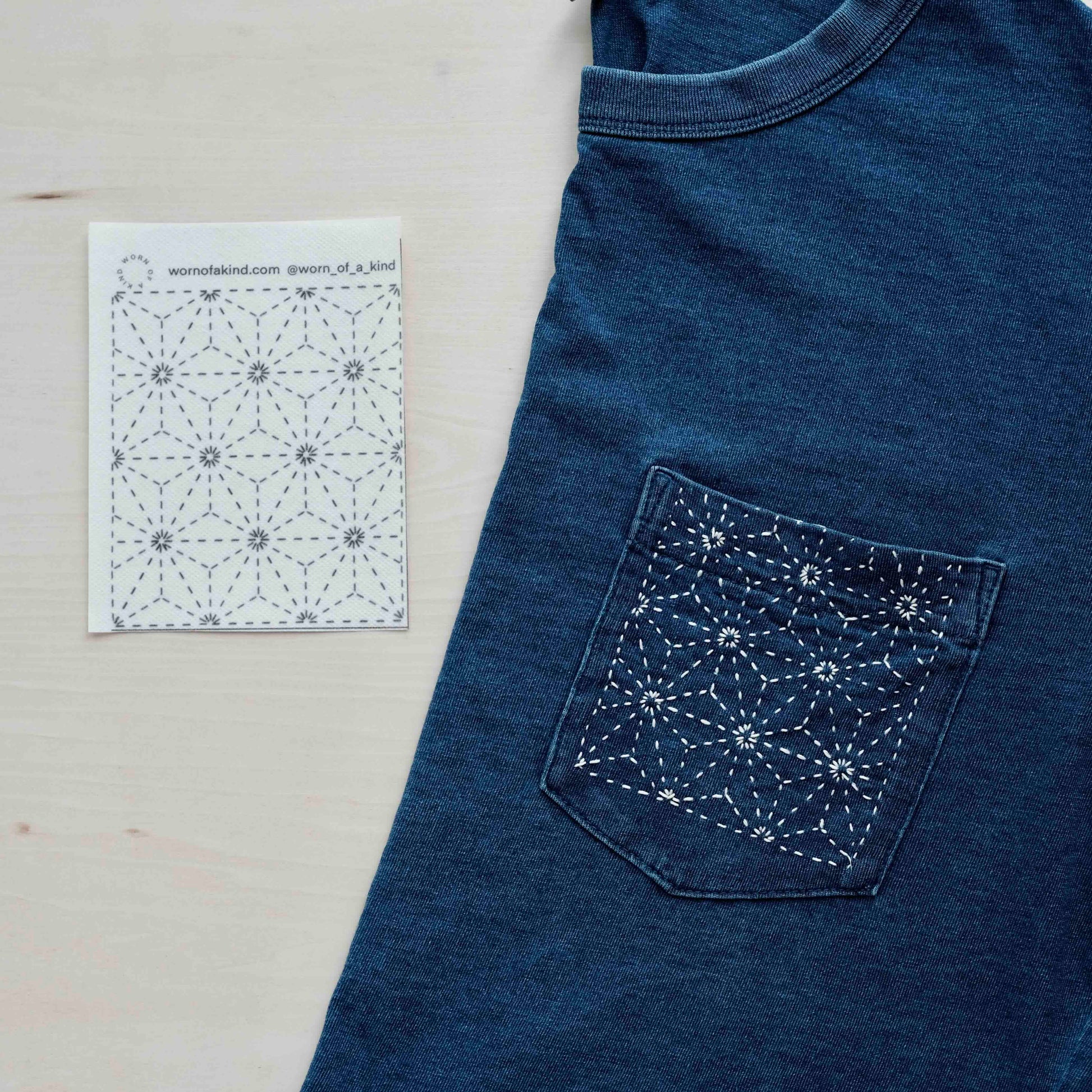 Indigo t-shirt featuring a white hemp leaf sashiko pattern next to a water-soluble transfer sticker.