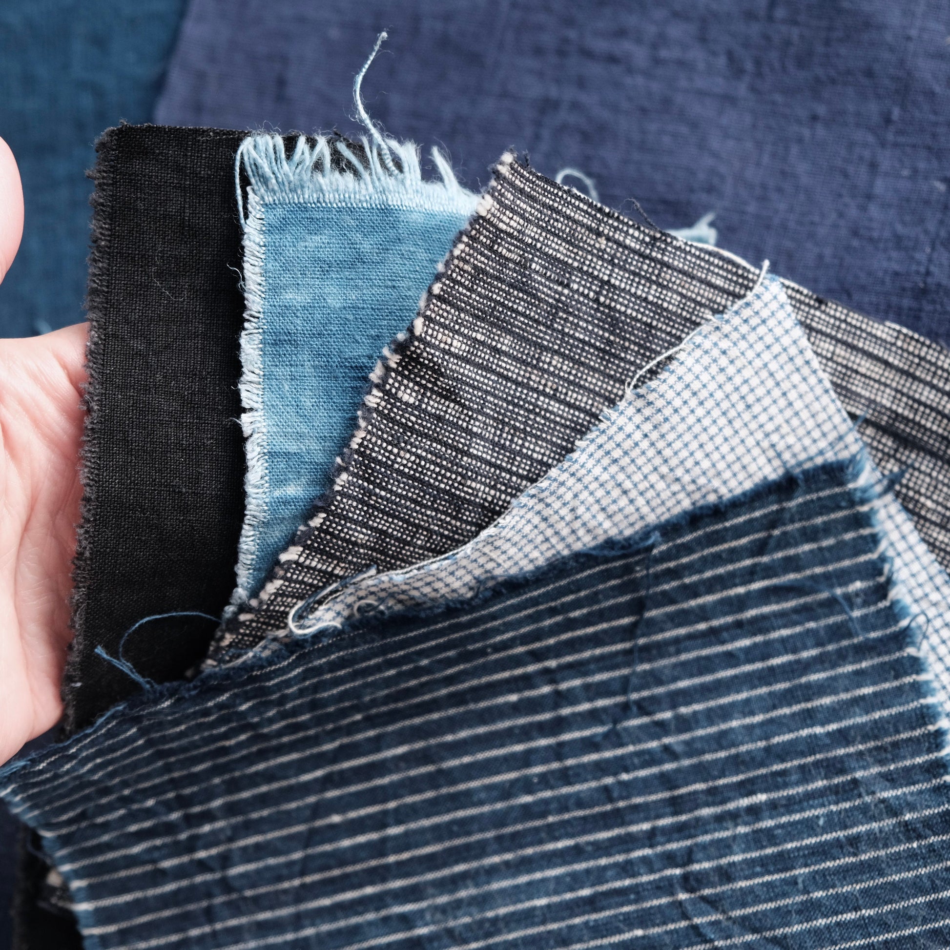 Close-up of smaller pieces of indigo and French linen from the boro bundle.