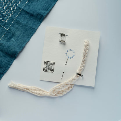Back of the Sashiko Starter Kit card showing the QR code, with all tools neatly packed