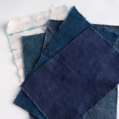 Close-up of large antique indigo and French linen pieces from the bundle.