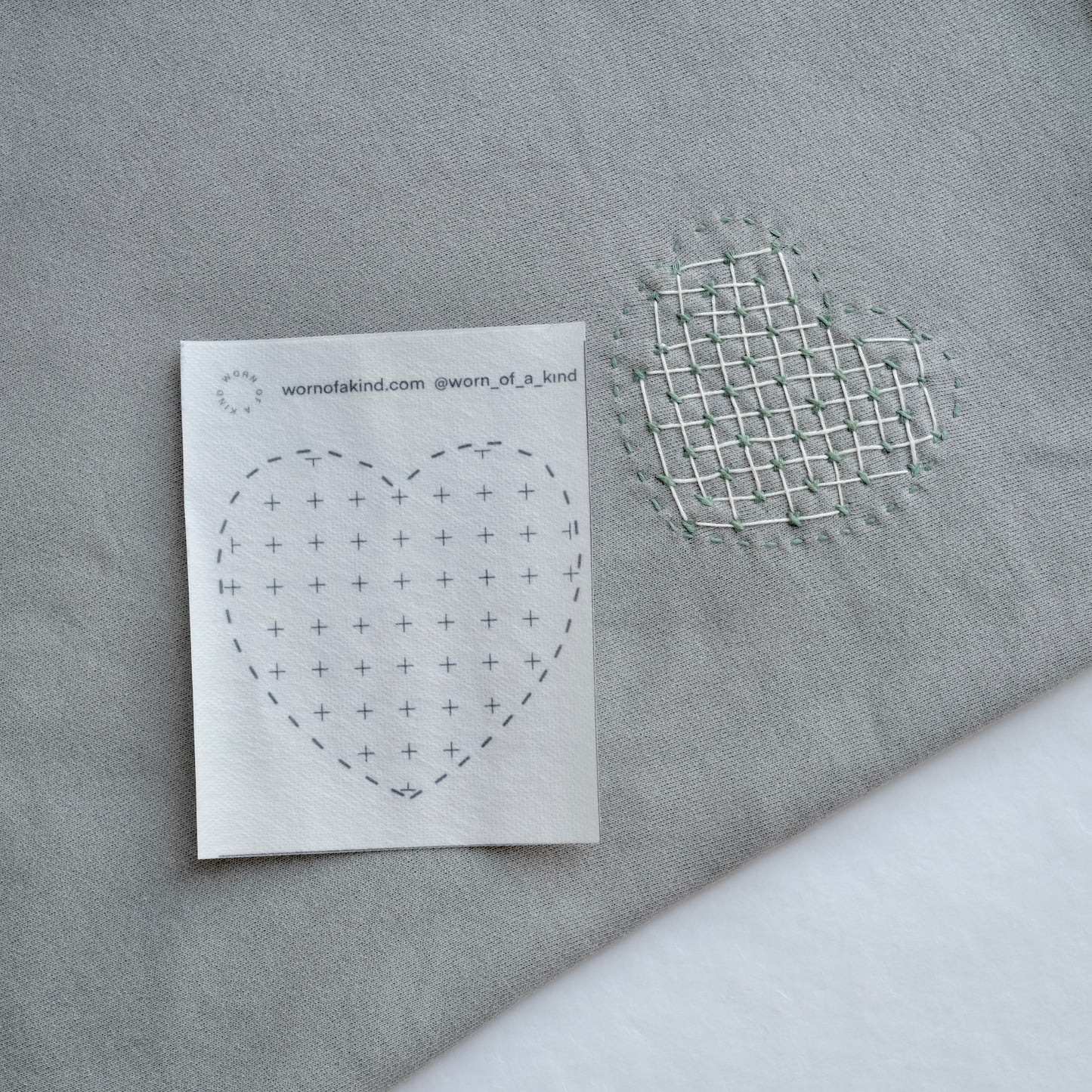 A heart-shaped Sashiko pattern featuring decorative weaving for a textured, layered look.