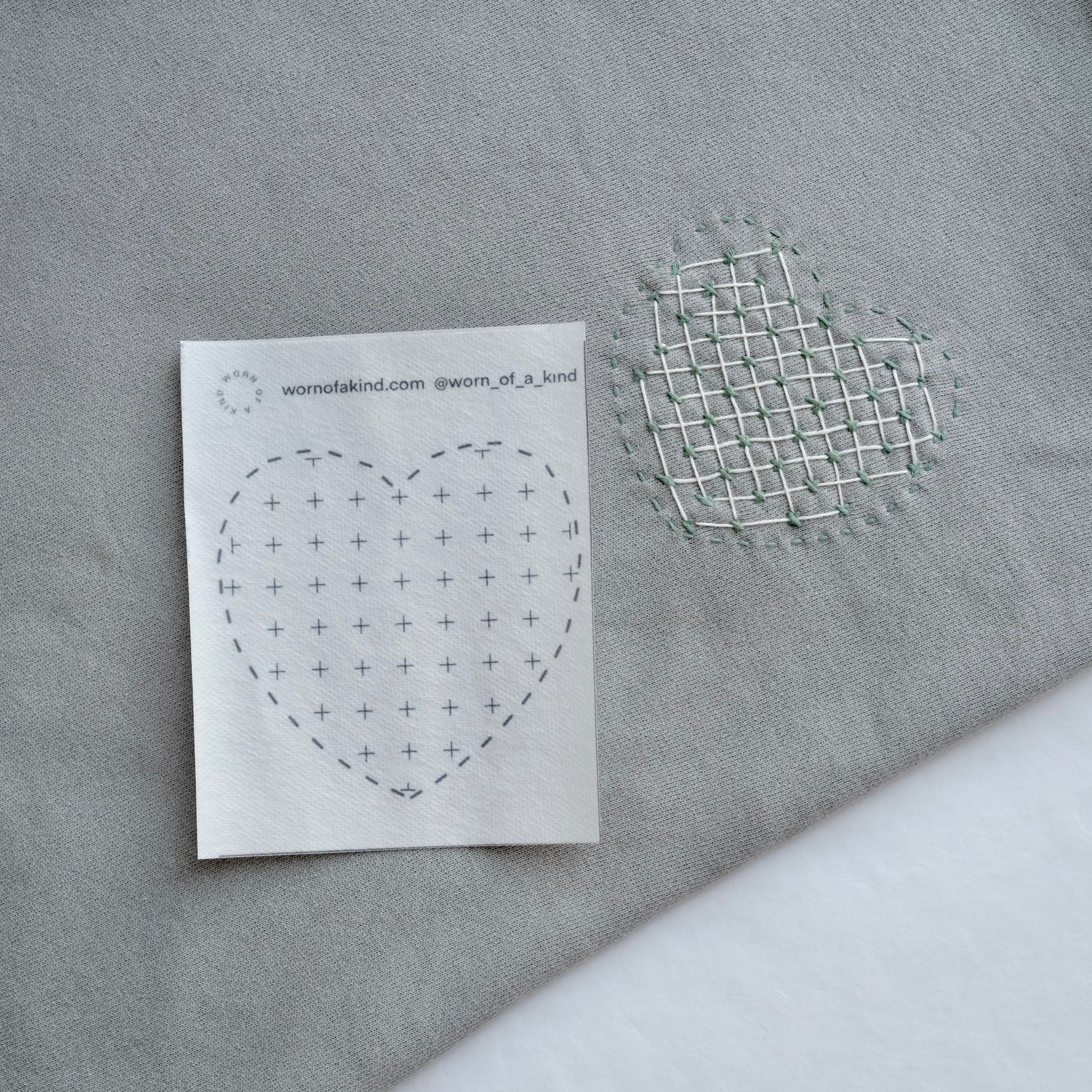 A heart-shaped Sashiko pattern featuring decorative weaving for a textured, layered look.