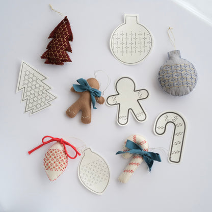 Collection of 5 Sashiko ornament transfers alongside finished festive felt decorations.