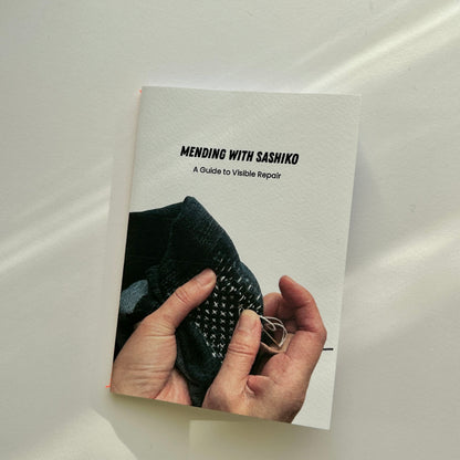 Close-up of the Mending with Sashiko pocket guide featuring illustrations and a 7-step blueprint.