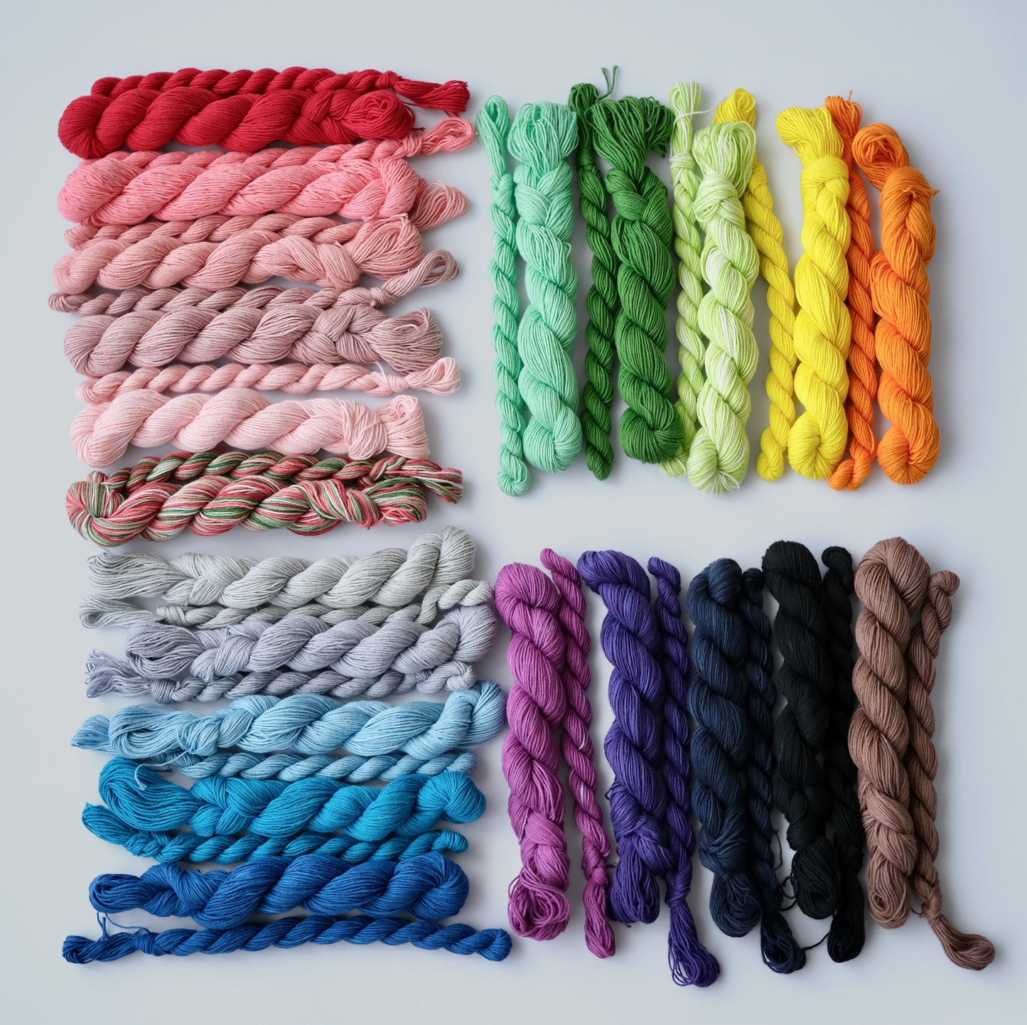 Full collection of 21 hand-dyed sashiko colors shown in both 20-meter and 80-meter skeins on a white background.