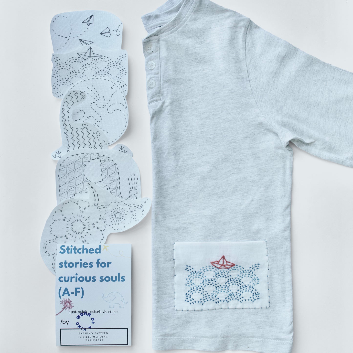Sashiko Stitched Stories kit packaging next to a grey jersey shirt with a boat mending patch.
