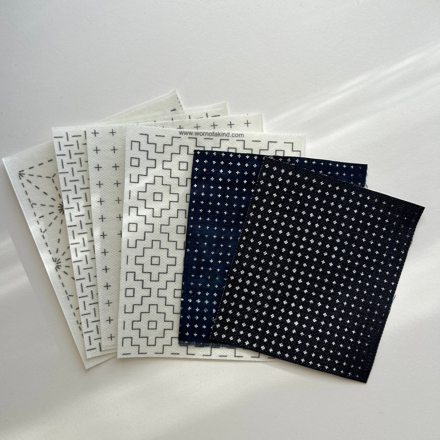 Water-soluble Stick n Stitch sashiko transfers and dark denim patches with pre-stenciled mending grids.