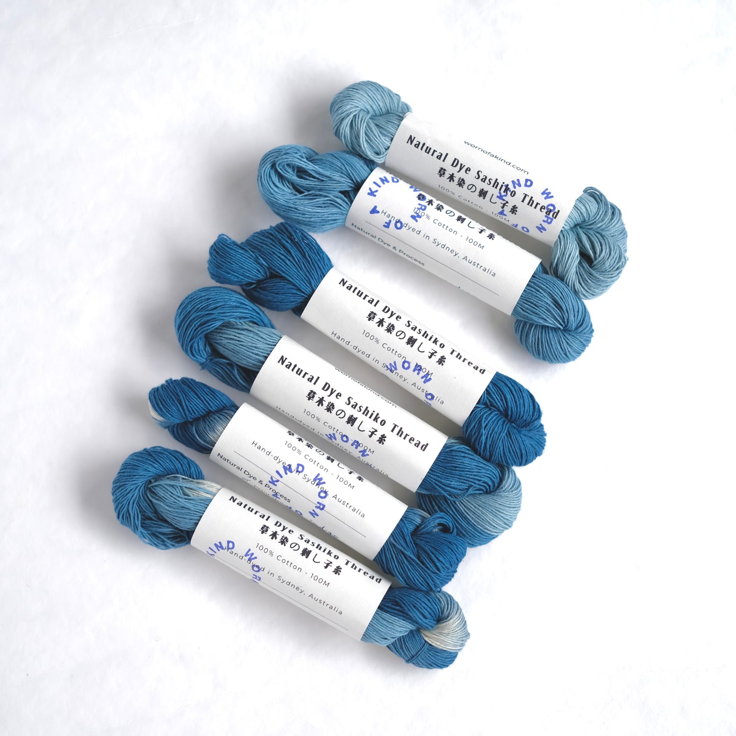 Hand-dyed indigo Sashiko thread skeins with Worn Of A Kind studio labels.