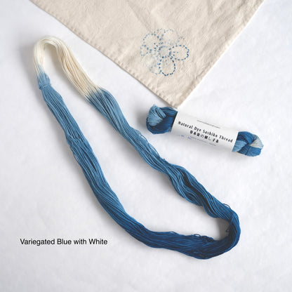 Variegated blue and white hand-dyed Sashiko thread with an open skein and stitching sample.