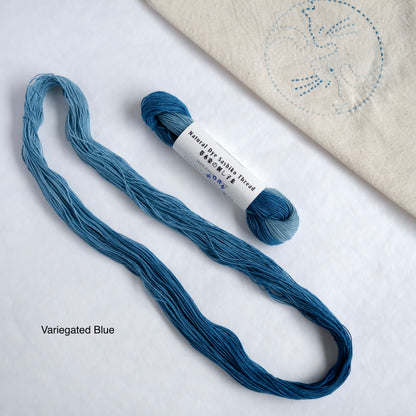 Variegated indigo thread featuring multiple shades of blue in one skein.